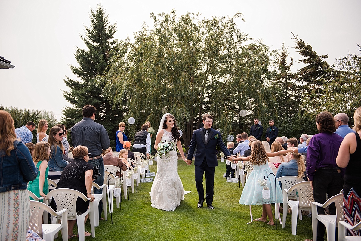 Rustic Alberta Outdoor Wedding | Red Deer Photographers | Stettler Photographers | Mason jars and paper lanterns wedding decor | Fishing themed wedding reception